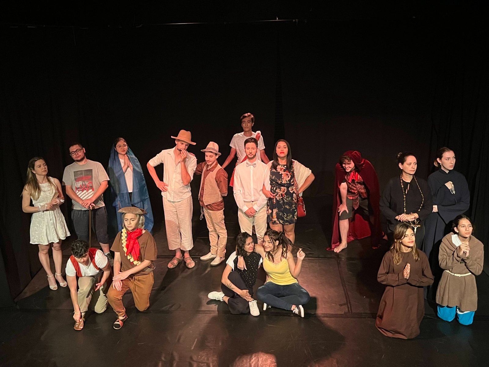 Theatre class ensemble in costume on stage